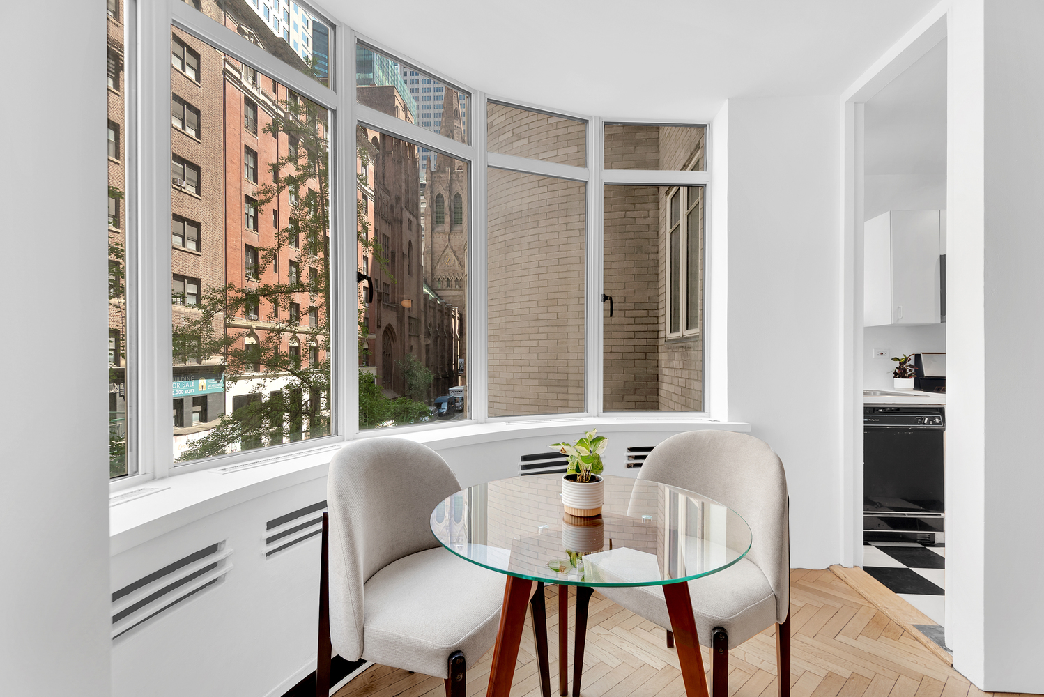24 West 55th Street, Unit 3D Manhattan, NY 10019 - Photo 2 of 10 a dining room with furniture and window