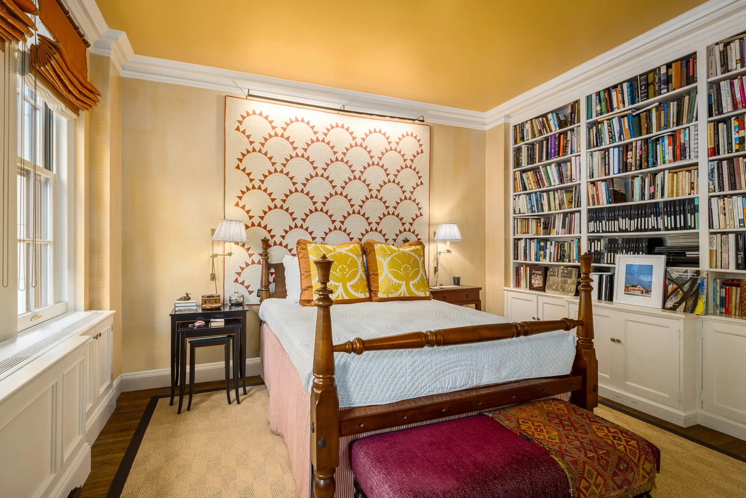a bedroom with a bed and a bookshelf with wooden floor