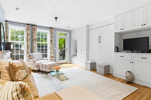a bedroom with furniture and a flat screen tv