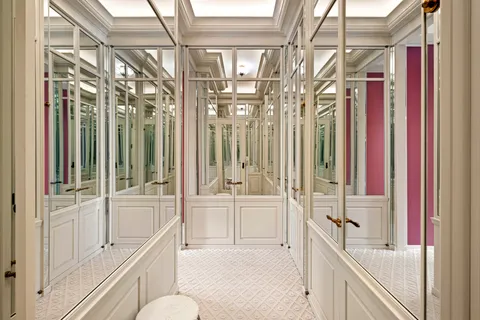 a spacious bathroom with a sink a large mirror and a shower