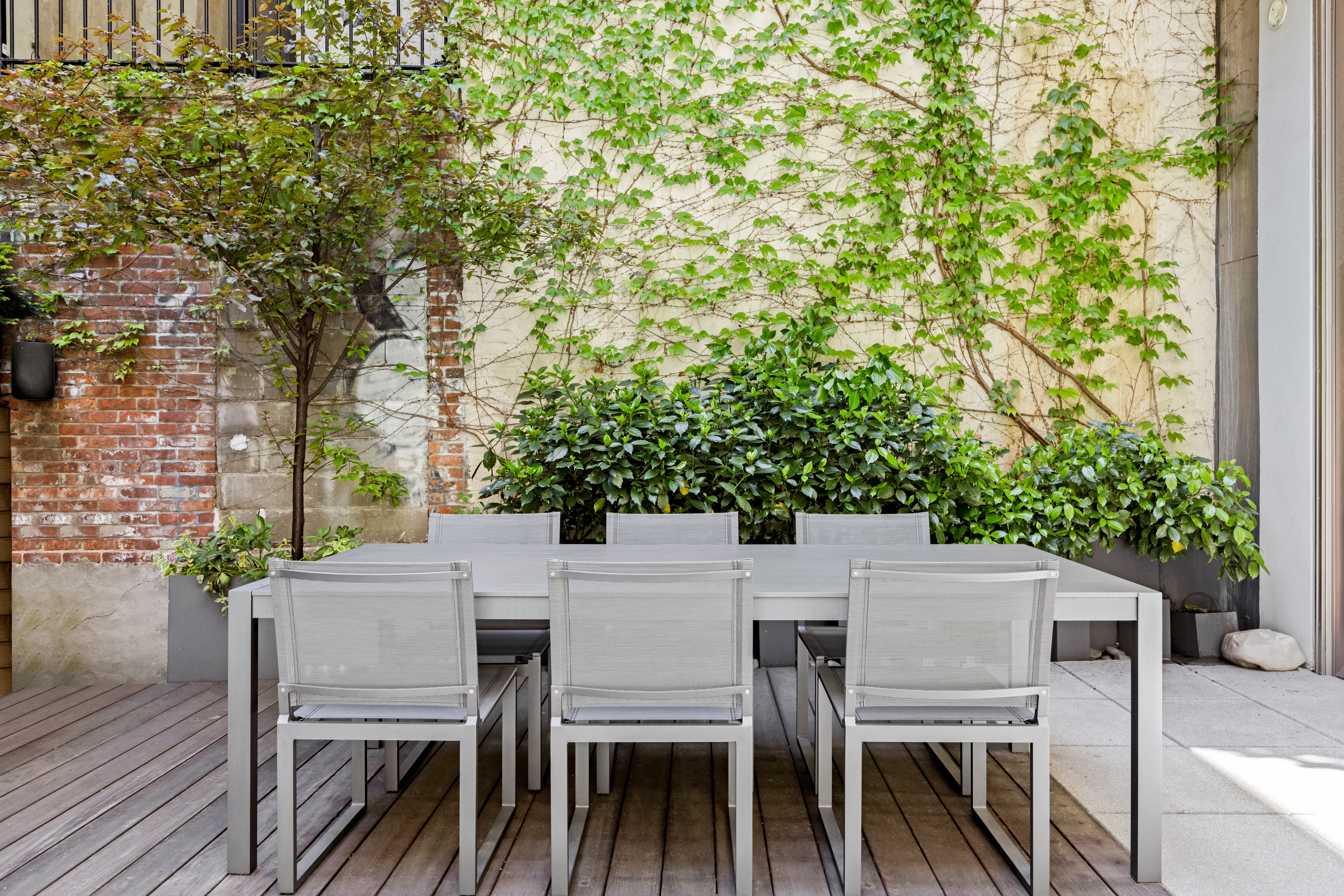 33 Vestry Street, Unit TH1 Manhattan, NY 10013 - Photo 5 of 17 a patio with table and chairs and potted plants