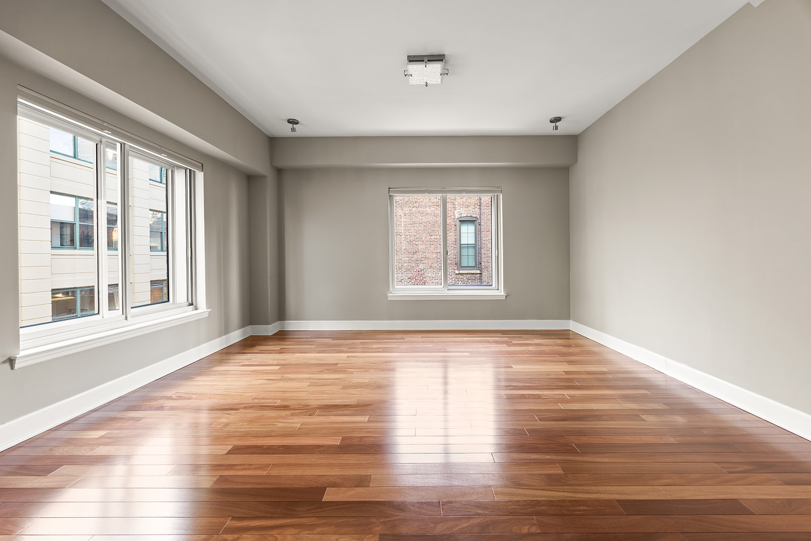 133 Water Street, Unit 8E Brooklyn, NY 11201 - Photo 2 of 16 a view of an empty room with wooden floor and a window
