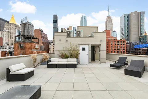 a living room with furniture a fireplace and a large window
