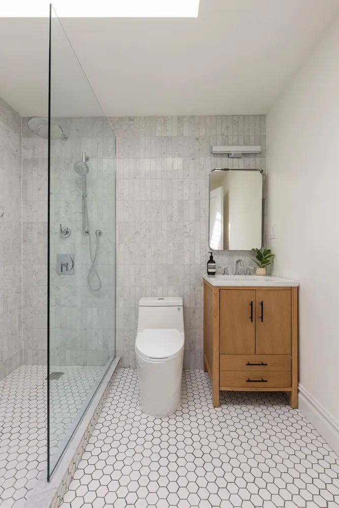 a bathroom with a granite countertop sink a toilet and a mirror