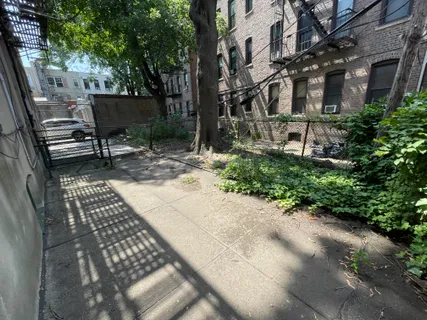 a view of a patio with table and chairs and potted plants