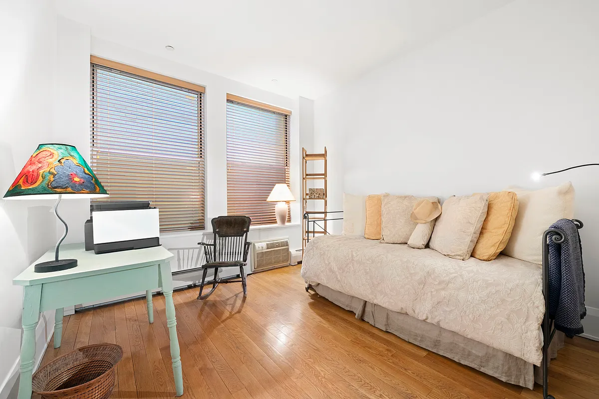 102 Fulton Street, Unit 2E Manhattan, NY 10038 - Photo 4 of 7 a living room with furniture and a wooden floor