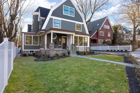a front view of a house with a yard table and chairs