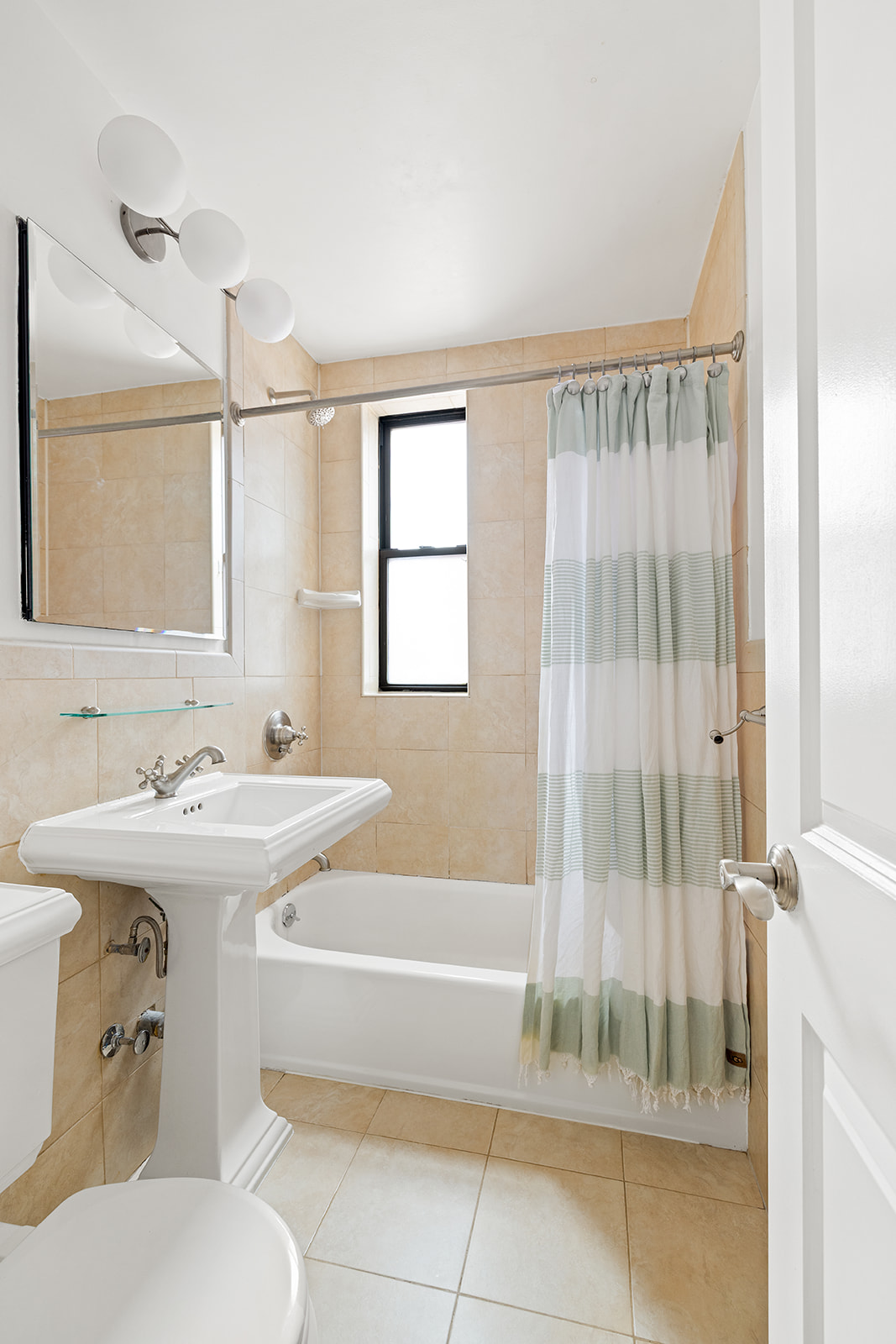 30 East 9th Street, Unit 5M Manhattan, NY 10003 - Photo 9 of 10 a bathroom with a tub sink and mirror