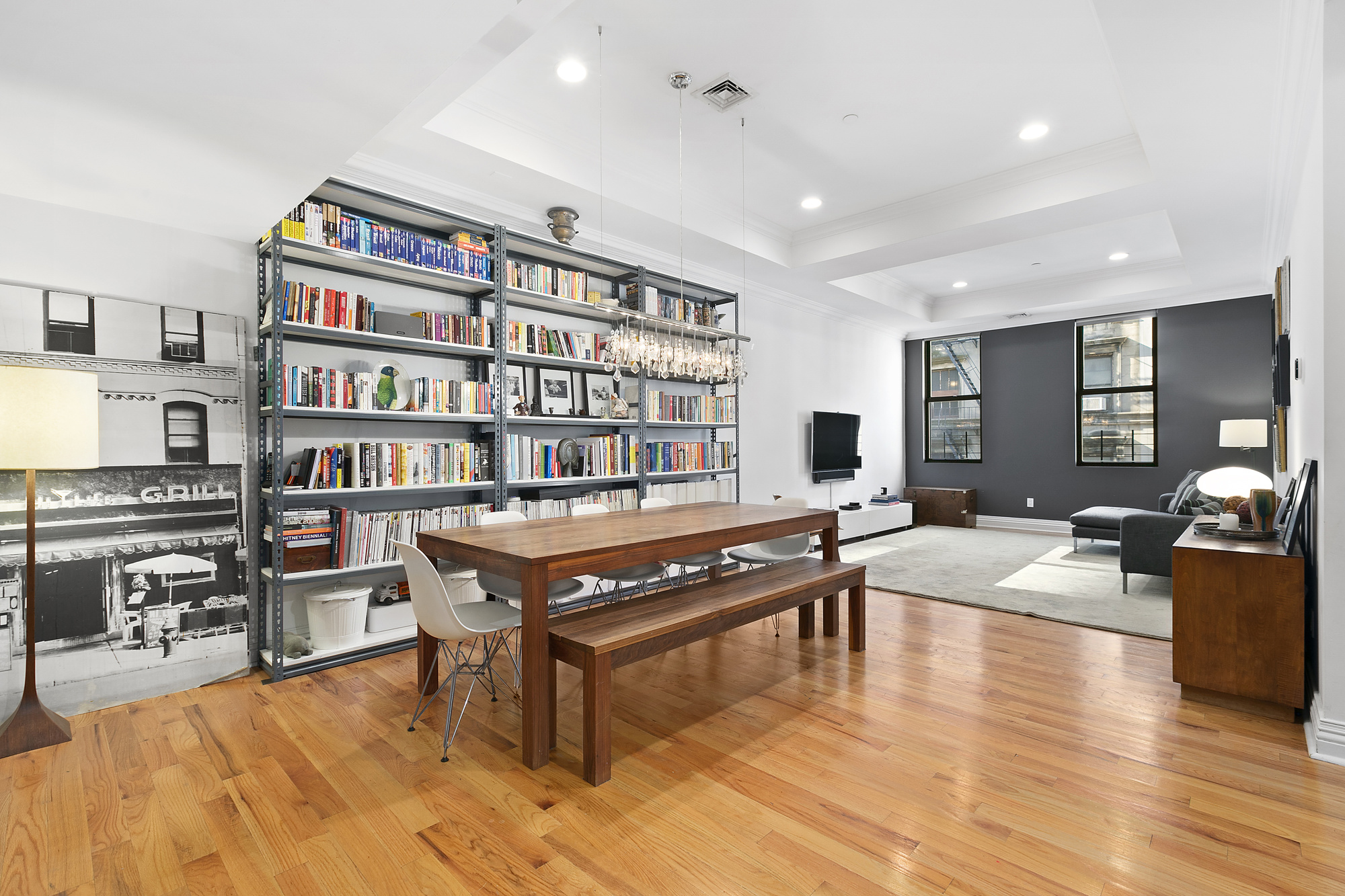 25 Murray Street, Unit 4A Manhattan, NY 10007 - Photo 3 of 11 a living room with furniture a rug and a book shelf