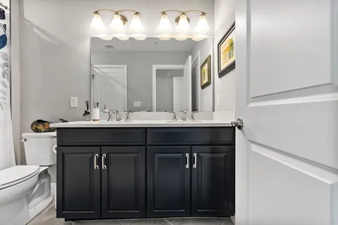 a bathroom with a sink vanity and a mirror