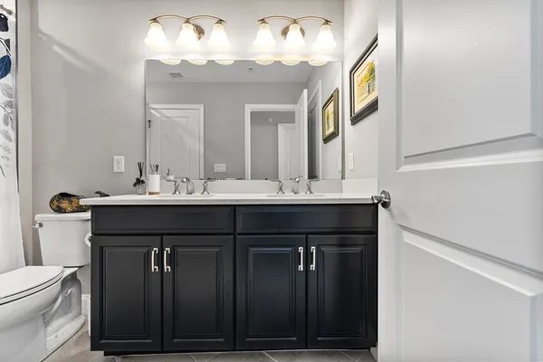 a bathroom with a sink vanity and a mirror