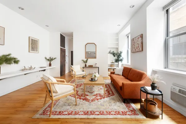 a living room with furniture and a rug