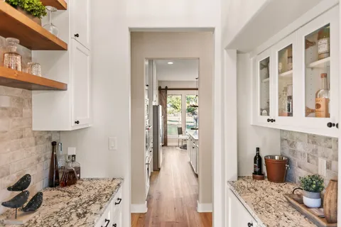 a view of a balcony with furniture and wooden floor