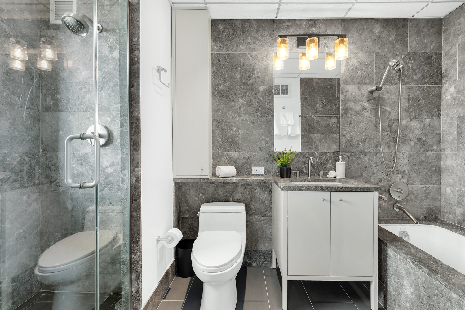 205 East 59th Street, Unit 19A Manhattan, NY 10022 - Photo 7 of 14 a bathroom with a toilet sink and mirror