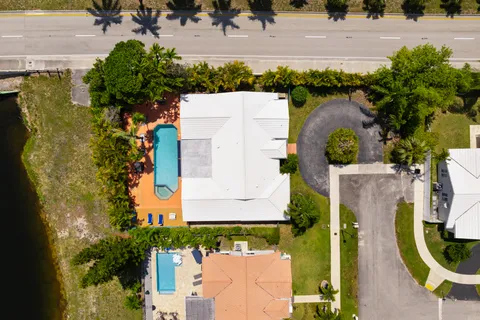 an aerial view of a house with a garden and swimming pool