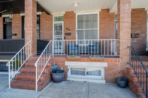 a view of a balcony with two chairs and a potted plant