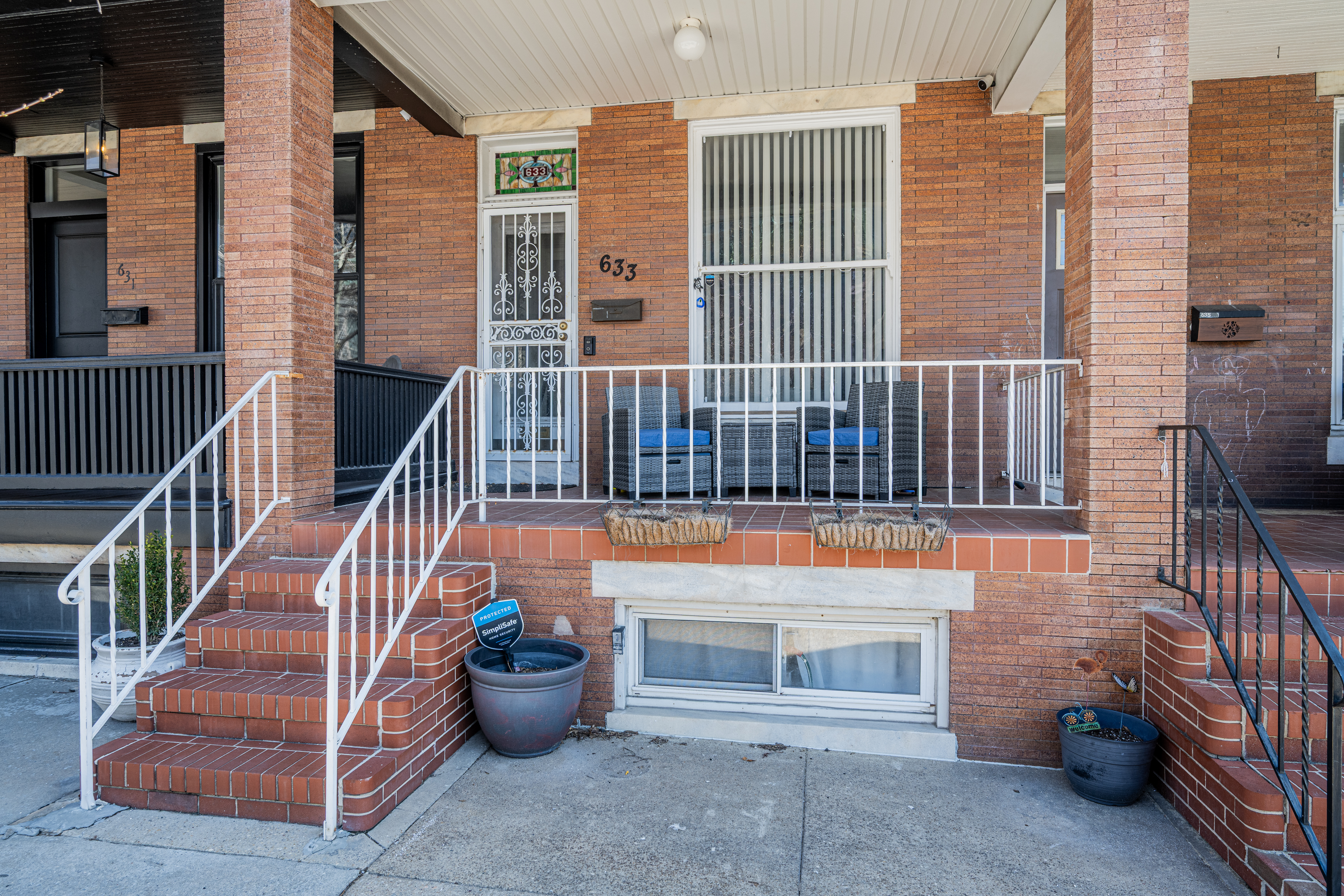 633 South Conkling Street Baltimore, MD 21224 - Photo 4 of 23 a view of a balcony with two chairs and a potted plant