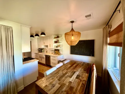 a spacious bedroom with wooden floor and furniture