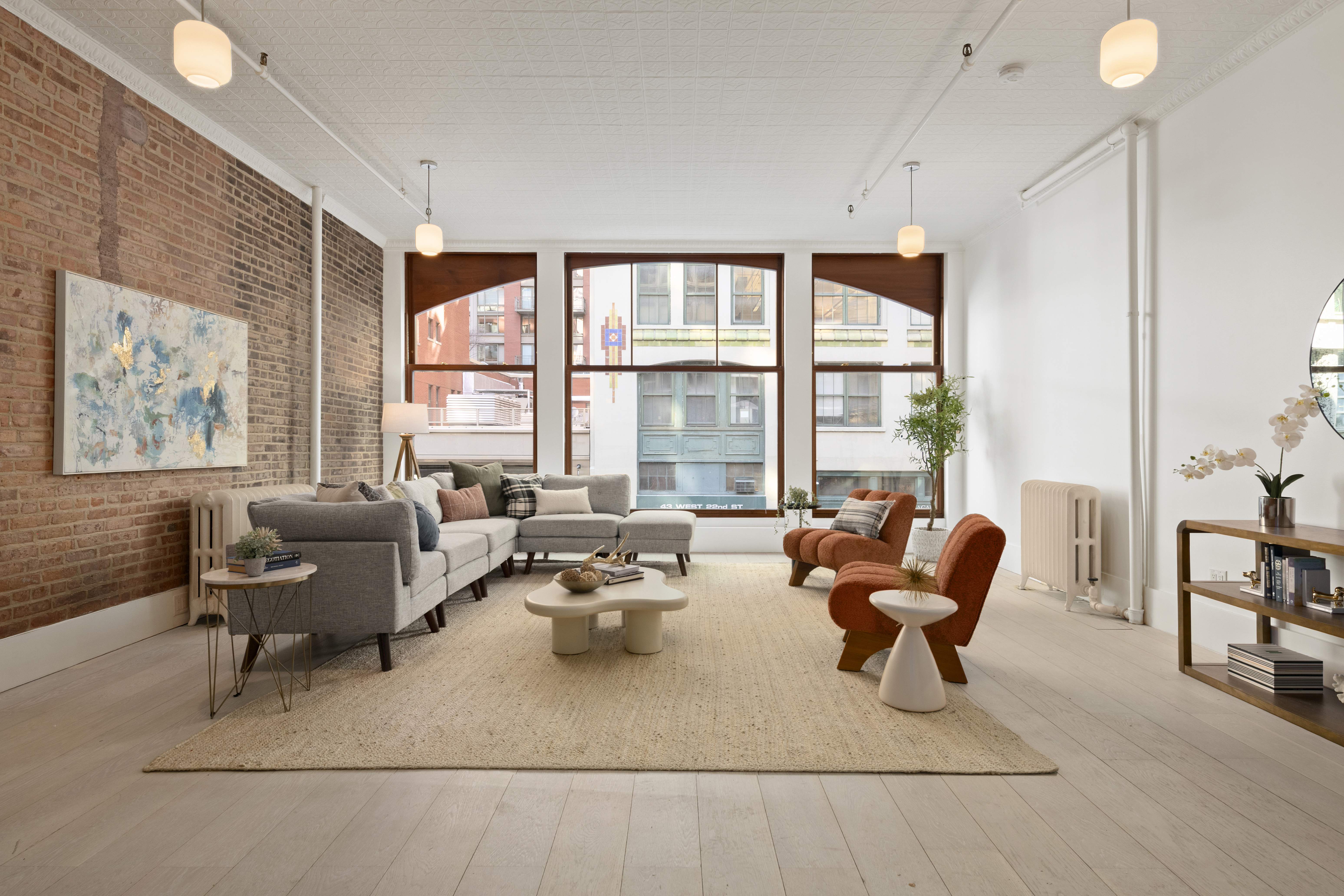 a living room with furniture and large windows
