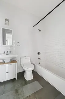 a bathroom with a toilet sink and bathtub