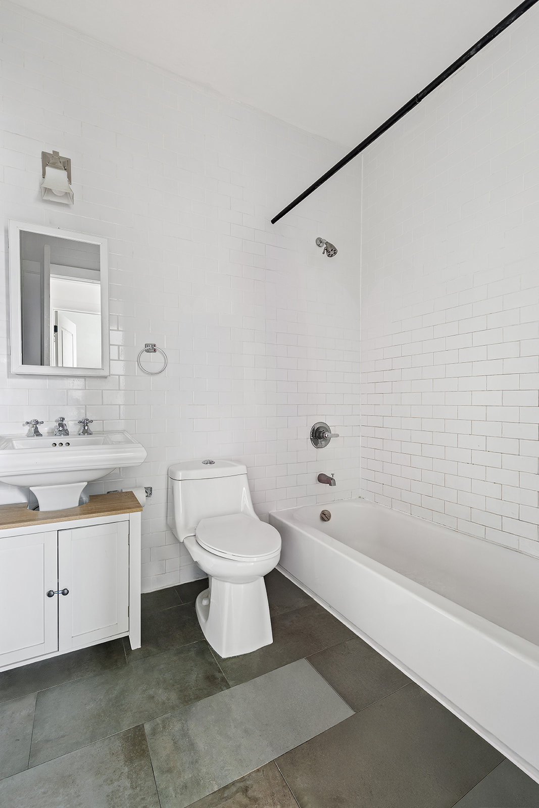 1474 Bushwick Avenue, Unit 4R Brooklyn, NY 11207 - Photo 5 of 8 a bathroom with a toilet sink and bathtub