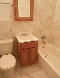 a bathroom with a sink a toilet and bathtub