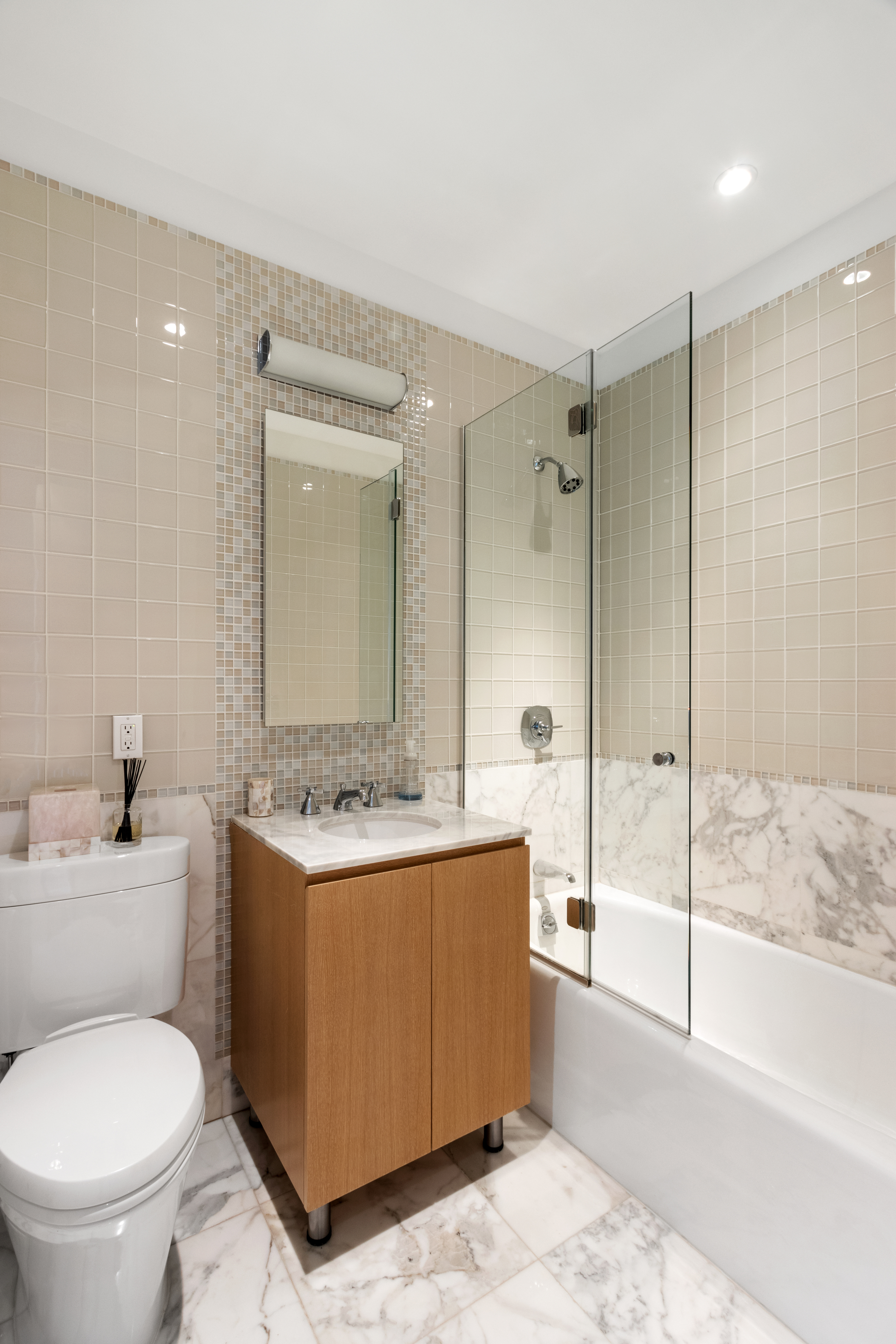 255 East 74th Street, Unit 25B Manhattan, NY 10021 - Photo 16 of 23 a bathroom with a sink toilet and shower