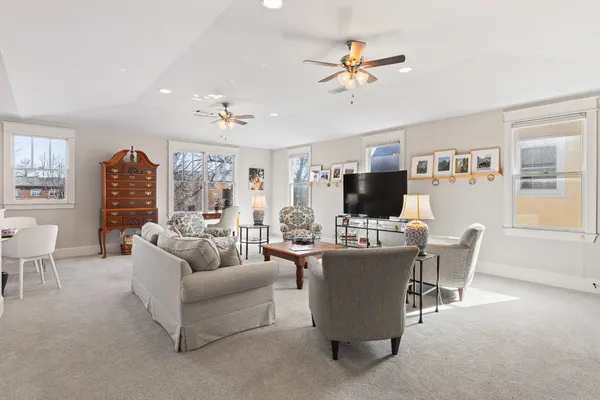 a living room with furniture a flat screen tv and a window