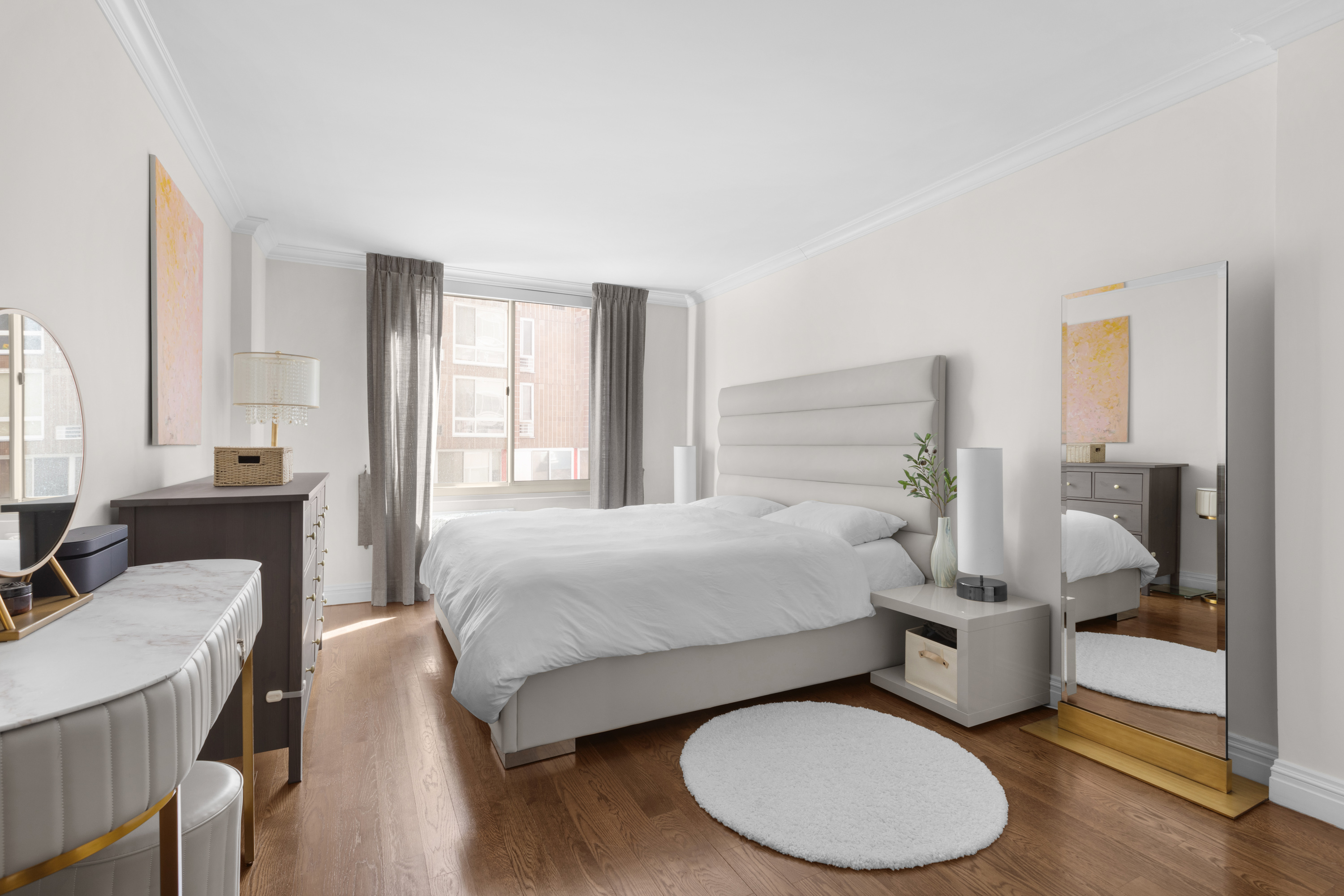575 Main Street, Unit 509 Manhattan, NY 10044 - Photo 8 of 25 a bedroom with a bed and wooden floor