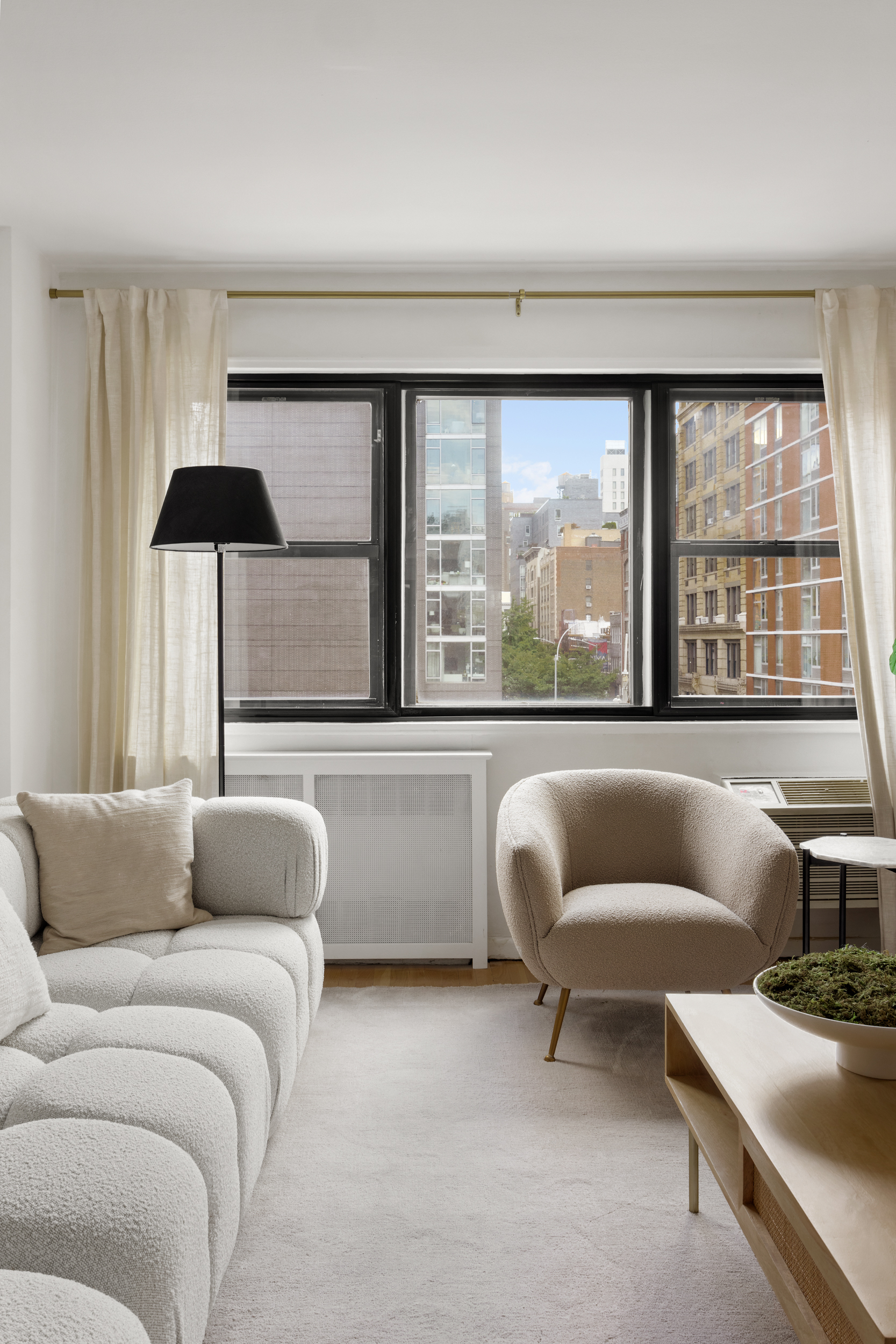 140 7th Avenue, Unit 4L Manhattan, NY 10011 - Photo 3 of 14 a living room with furniture and a large window