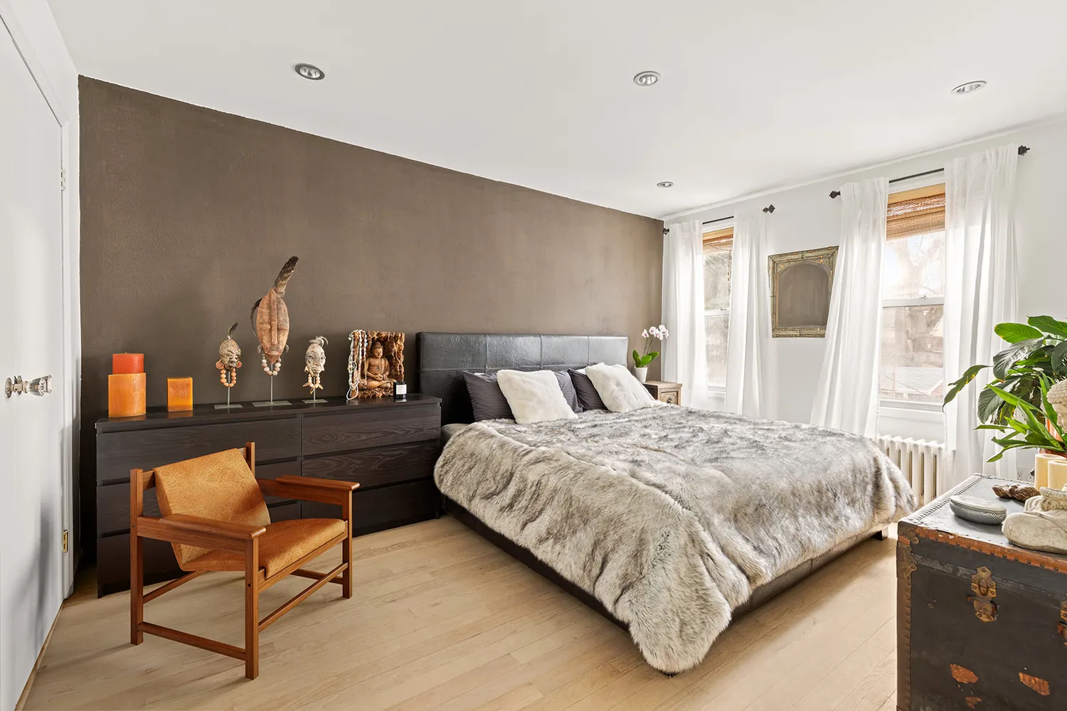 a bed room with a bed and a chair