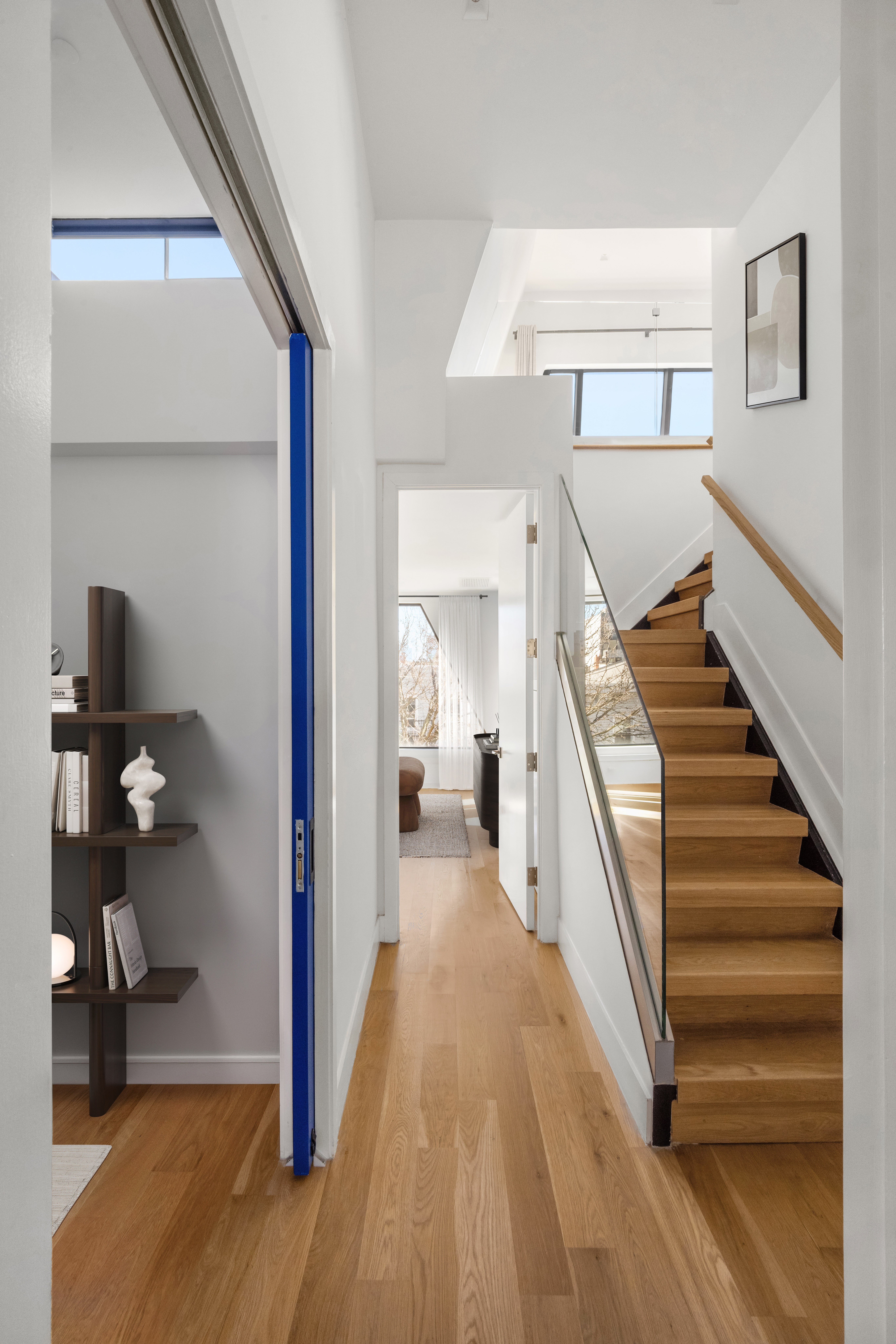 205 Freeman Street, Unit PH Brooklyn, NY 11222 - Photo 6 of 17 a view of a hallway with wooden floor and staircase