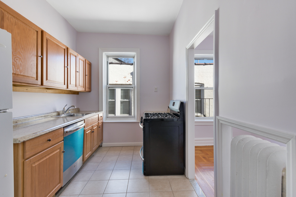 a kitchen with a refrigerator and a sink