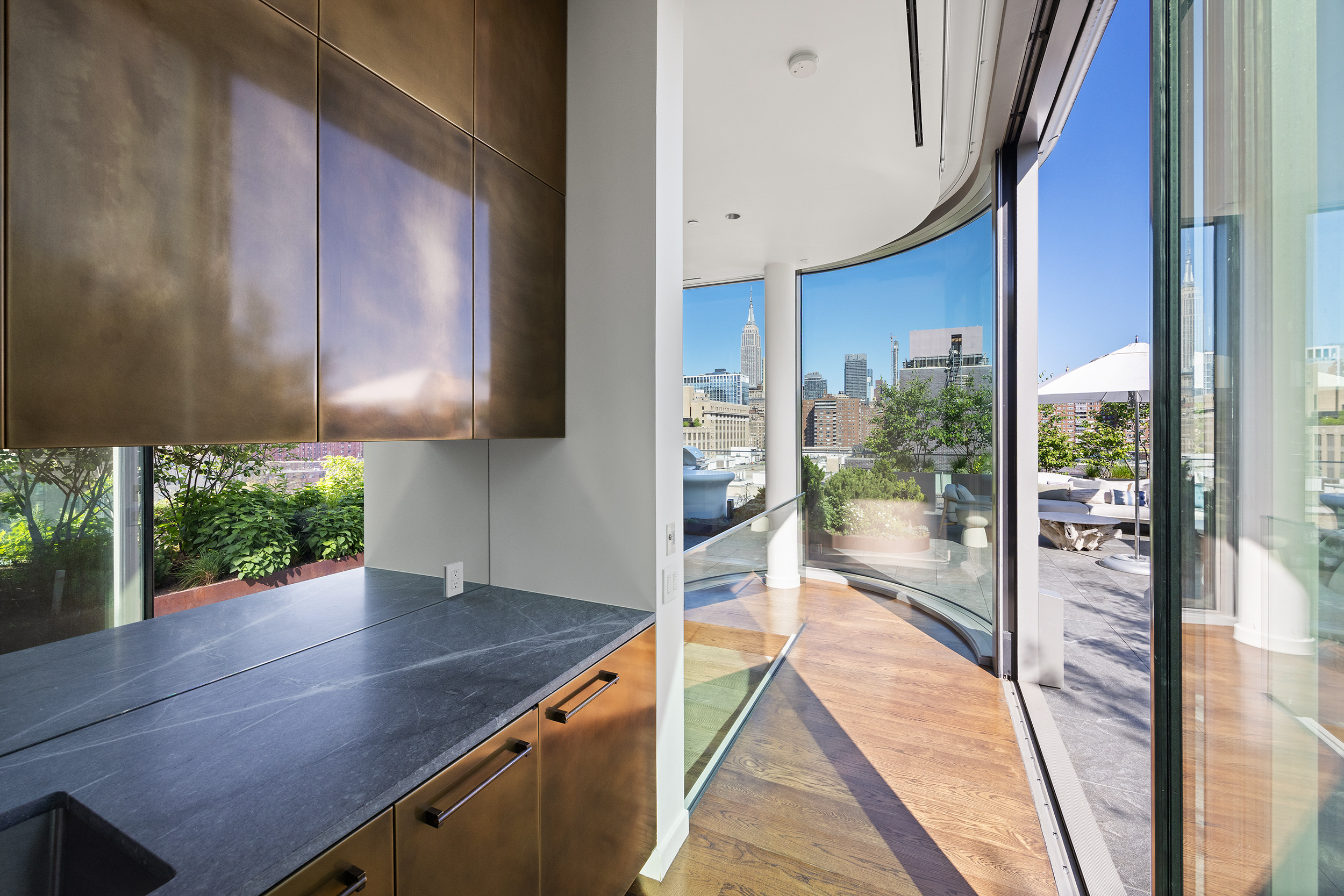 520 West 28th Street, Unit PH37 Manhattan, NY 10001 - Photo 17 of 45 a kitchen with a wooden floor and a large window