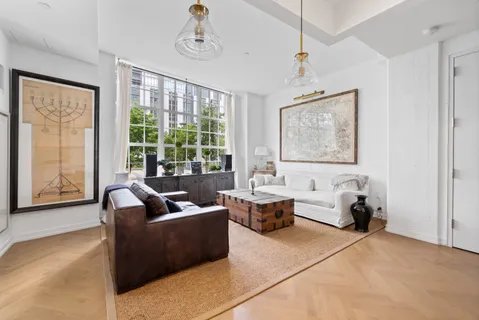 a living room with furniture and large windows