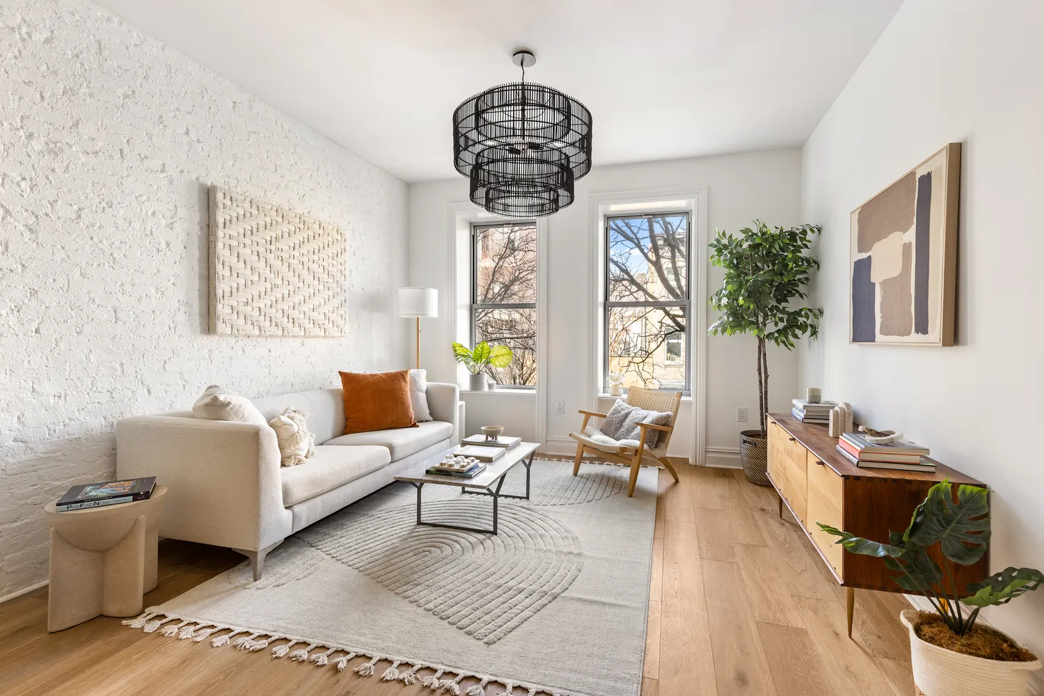 a living room with furniture a rug and a chandelier