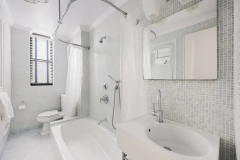a bathroom with a bathtub and shower