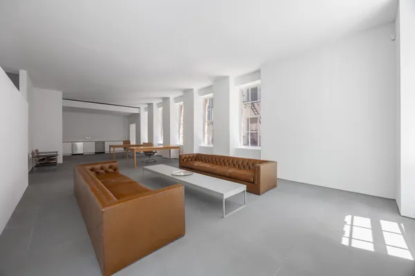 a living room with furniture and a pool table