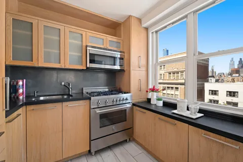 a kitchen with stainless steel appliances a stove a sink and a microwave