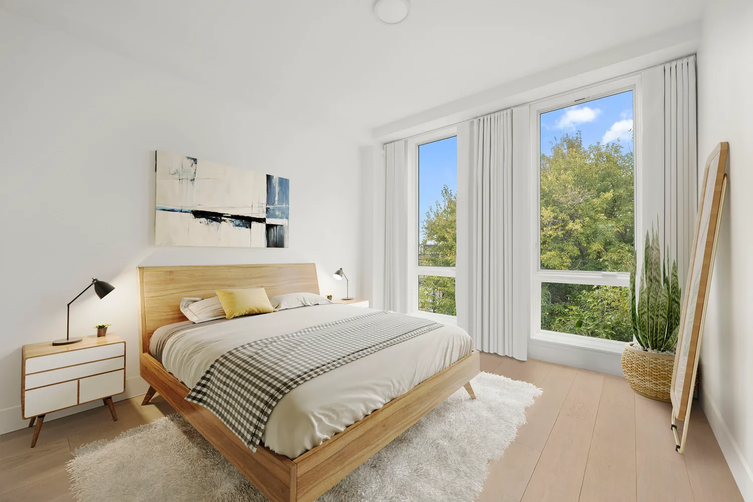 a bedroom with a bed and a large window