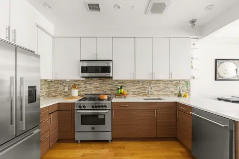 a kitchen with a sink stove and microwave