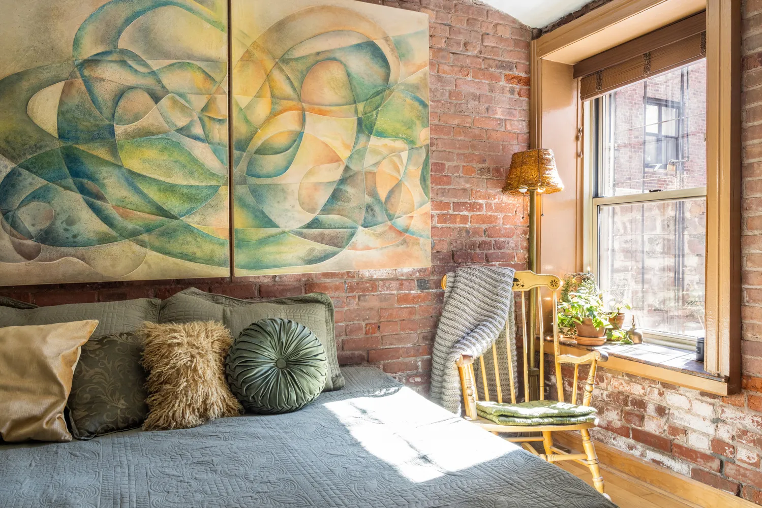 a bed sitting in a bedroom next to a window