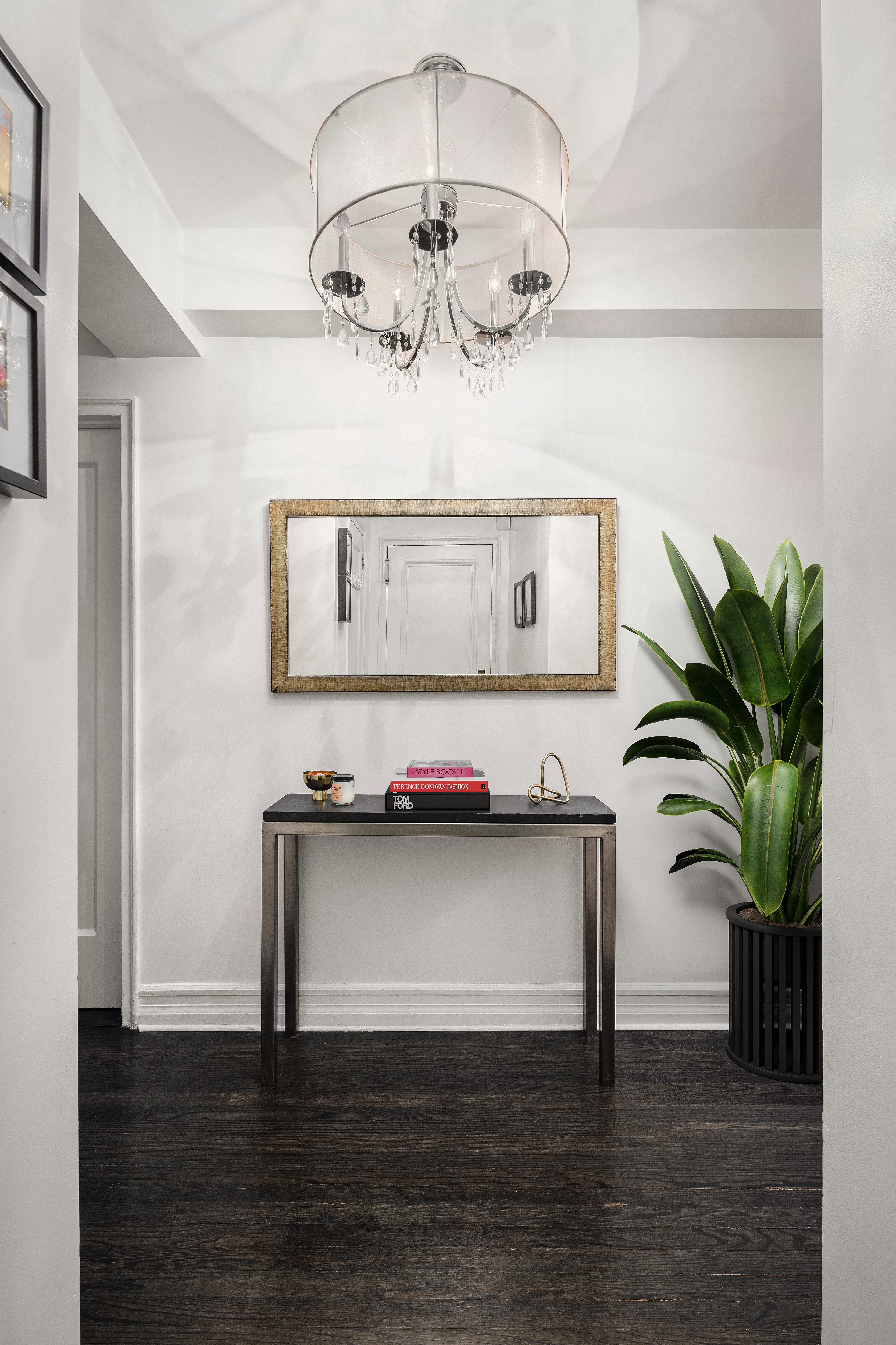 470 West 24th Street, Unit 2C Manhattan, NY 10011 - Photo 9 of 15 a view of a hallway with wooden floor and a chandelier