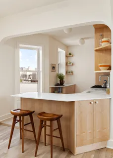 a living room with a table and chairs