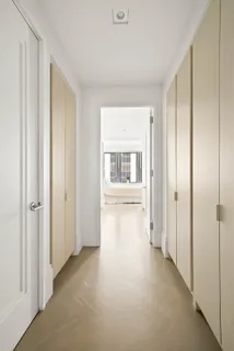a view of a hallway with wooden shelves