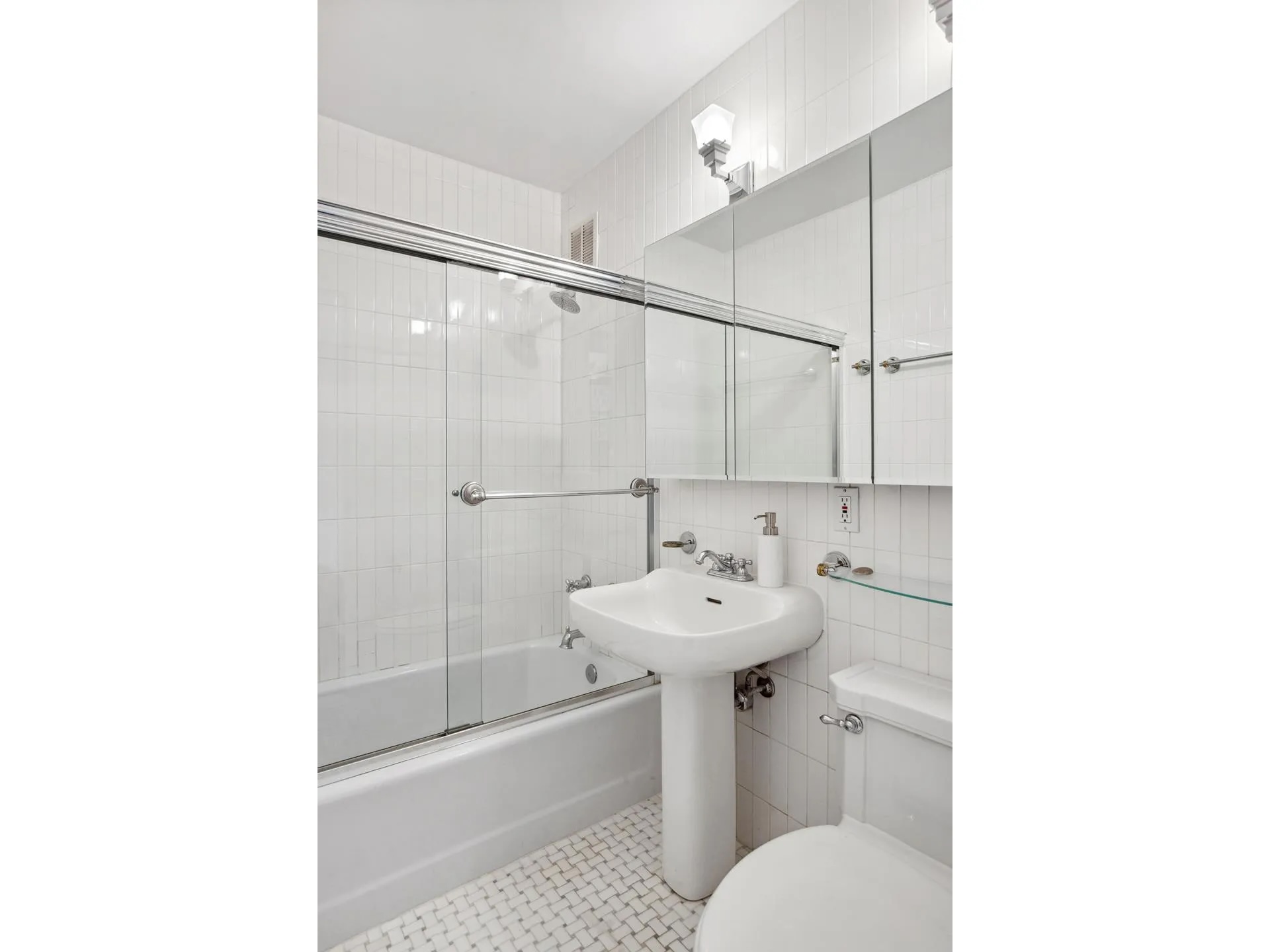 115 East 87th Street, Unit 18A Manhattan, NY 10128 - Photo 10 of 13 a bathroom with a sink toilet and shower