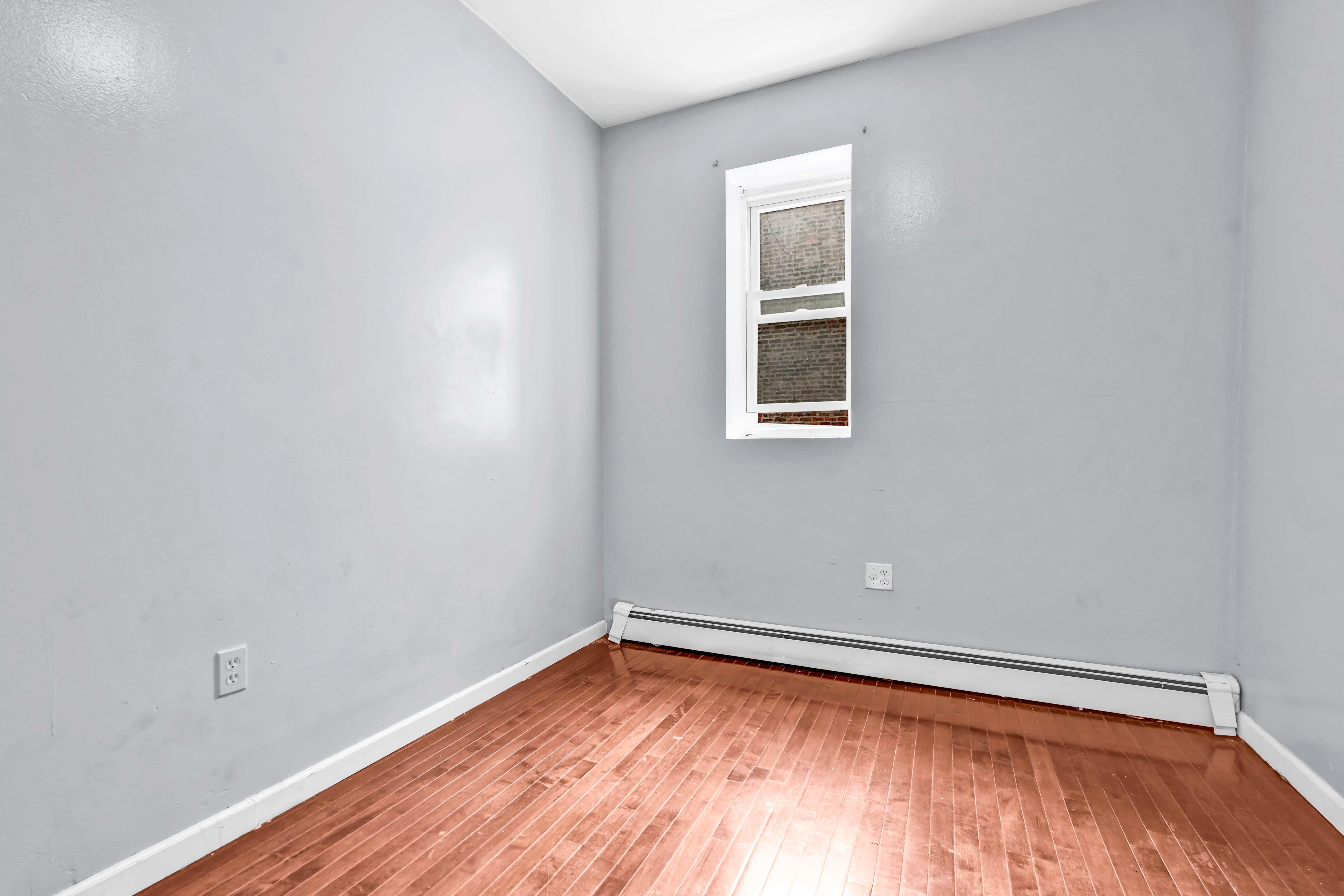 1633 St Johns Place, Unit 3 Brooklyn, NY 11233 - Photo 16 of 29 a view of a room with wooden floor and a window