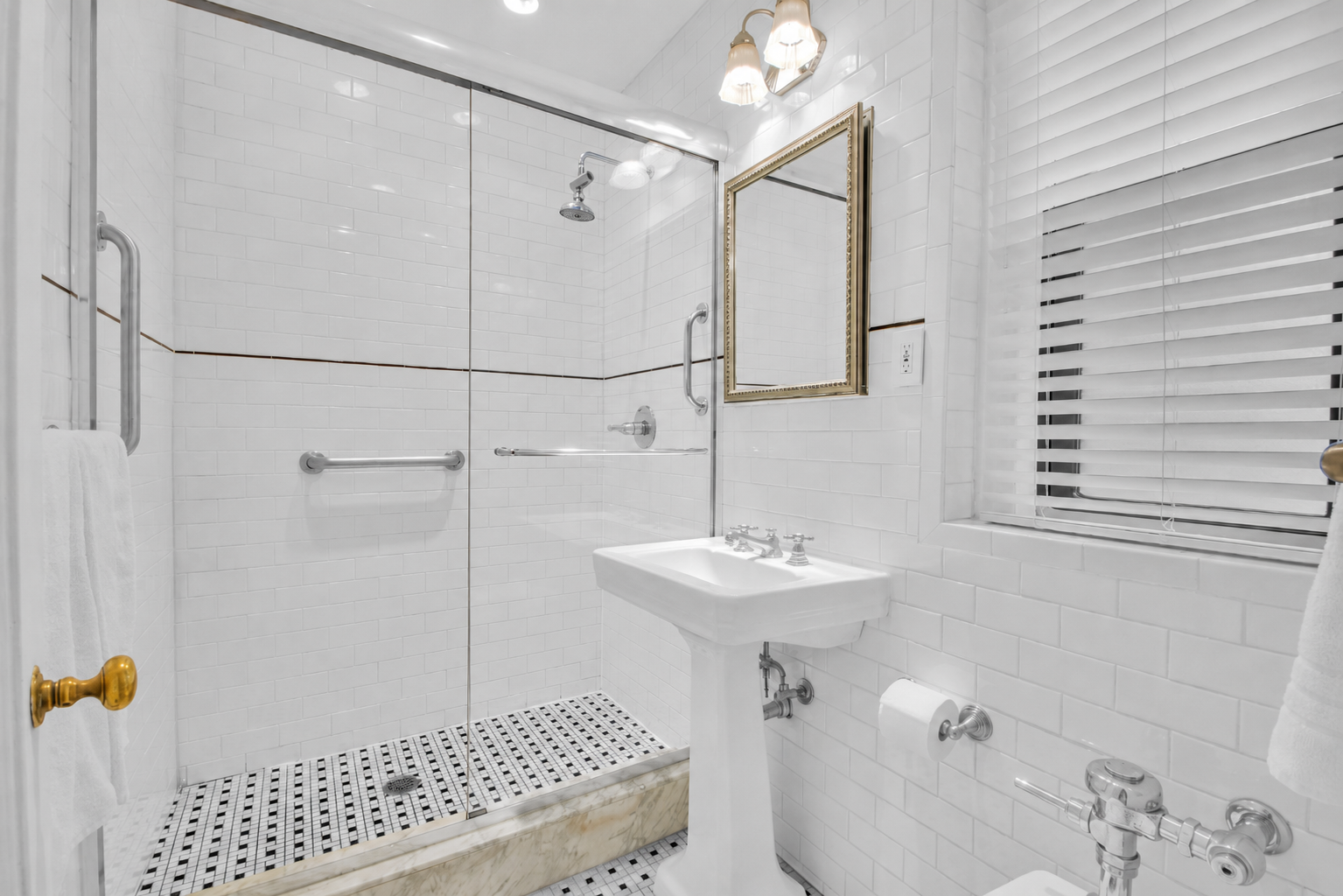 225 West 25th Street, Unit 5K Manhattan, NY 10001 - Photo 11 of 17 a bathroom with a sink a mirror and shower