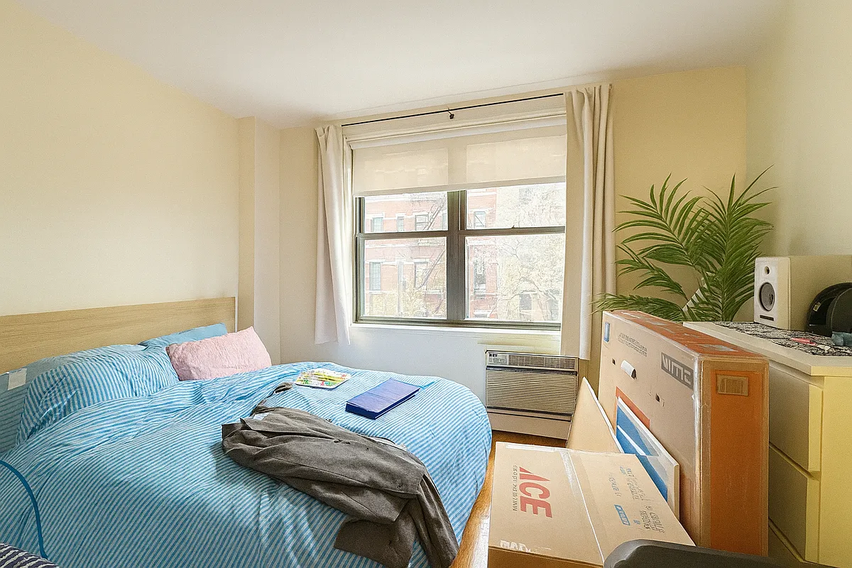 229 East 29th Street, Unit 3A Manhattan, NY 10016 - Photo 3 of 7 a bed sitting in a bedroom next to a window