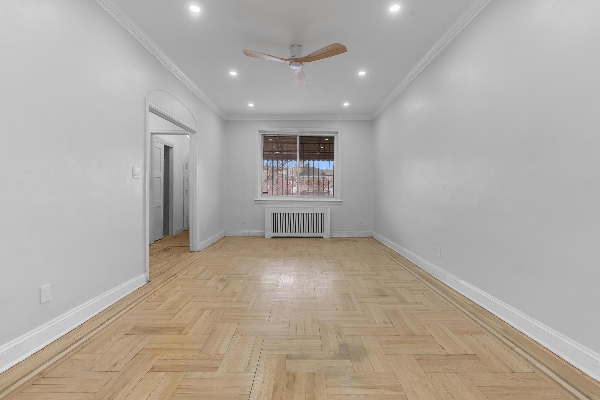 237 Remsen Avenue, Unit 1 Brooklyn, NY 11212 - Photo 14 of 16 an empty room with windows and ceiling fan